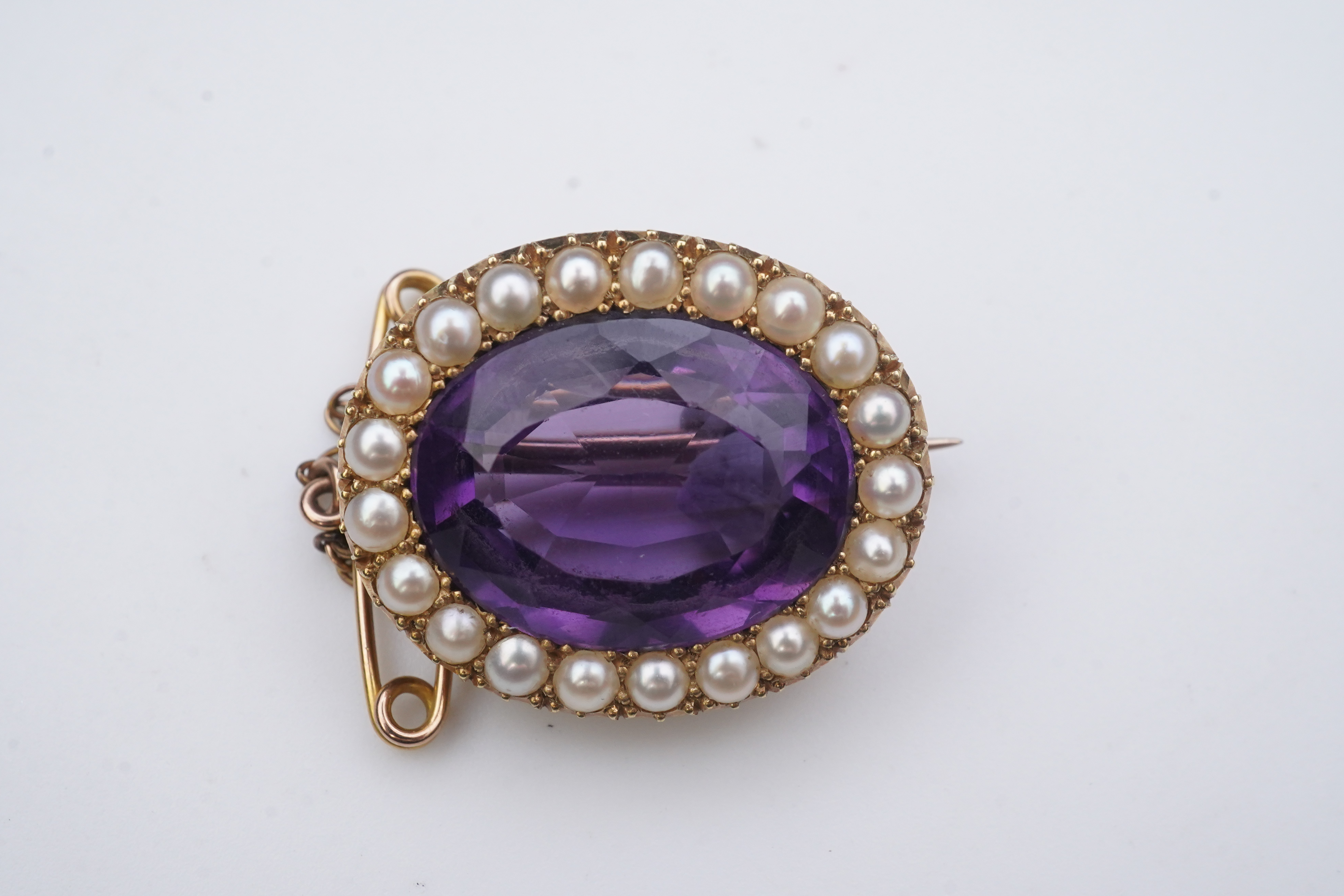 An amethyst and split pearl brooch, circa 1900